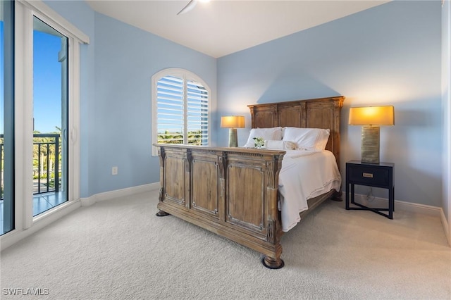 bedroom featuring access to exterior, ceiling fan, and light colored carpet