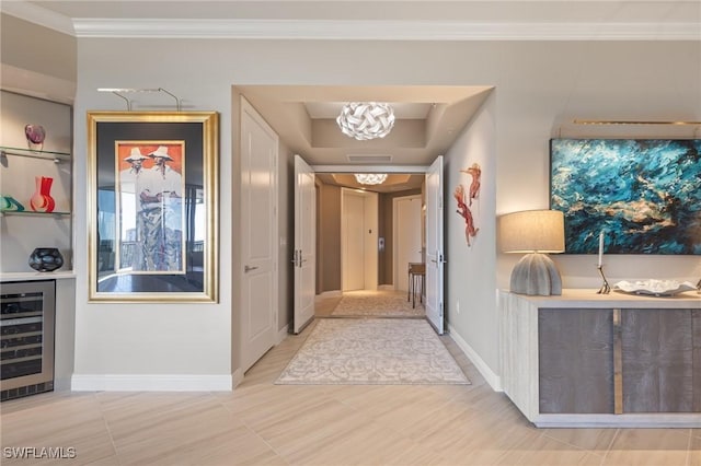 hallway with wine cooler, ornamental molding, and a notable chandelier