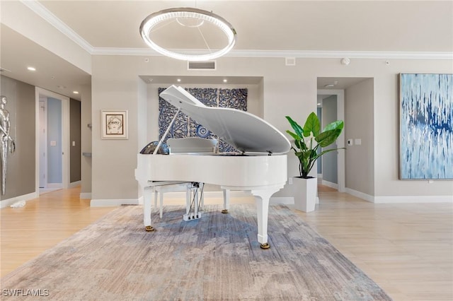 living area featuring light hardwood / wood-style flooring and ornamental molding