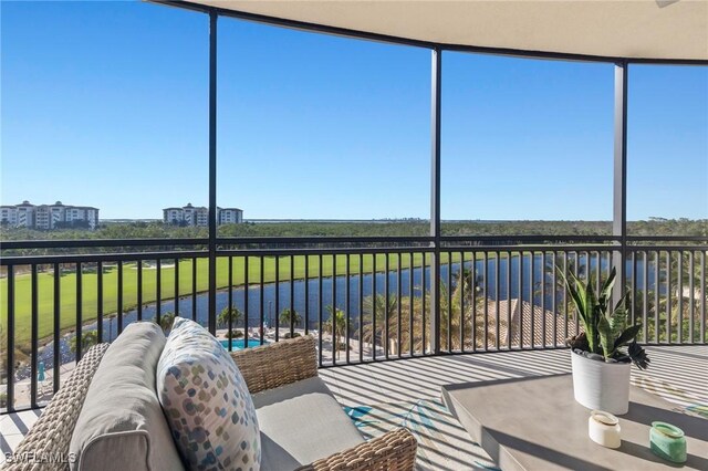 sunroom / solarium with a water view