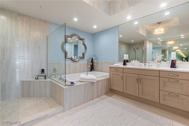 bathroom with plus walk in shower, vanity, a chandelier, and tile patterned floors