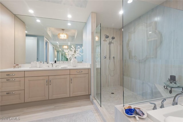 bathroom with a tile shower and vanity