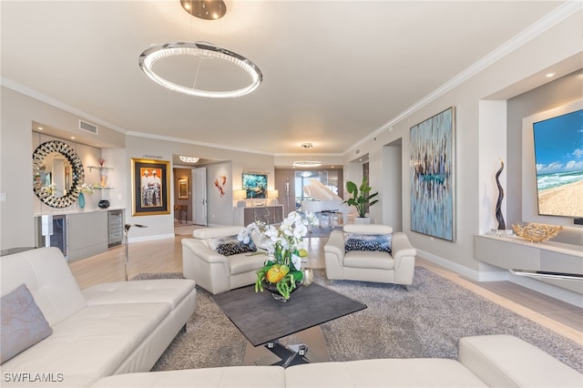 living room with hardwood / wood-style flooring and ornamental molding