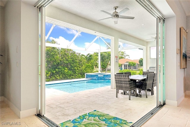 view of pool with an in ground hot tub, a lanai, ceiling fan, and a patio area