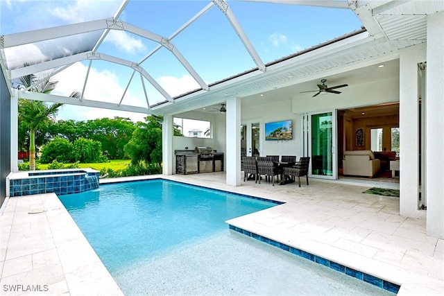 view of swimming pool with area for grilling, an in ground hot tub, a lanai, ceiling fan, and a patio area