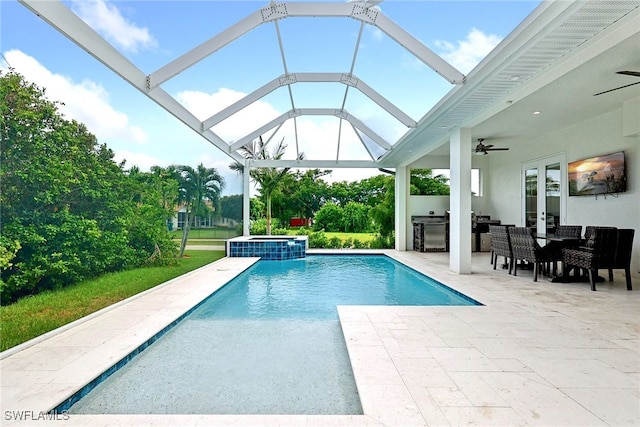 view of swimming pool with glass enclosure, ceiling fan, an in ground hot tub, and a patio area