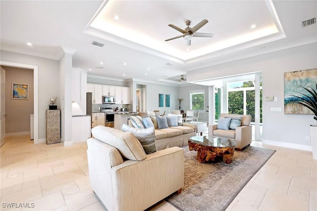 101 Bald Eagle Dr, Marco Island, FL 34145 - living room with a tray ceiling, a ceiling fan, recessed lighting, stone tile floors, and baseboards