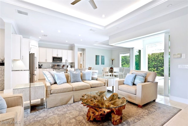 tiled living room featuring ceiling fan, crown molding, and sink