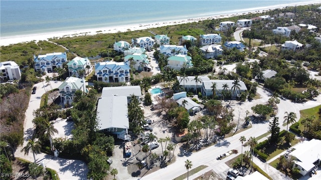 aerial view with a water view and a beach view