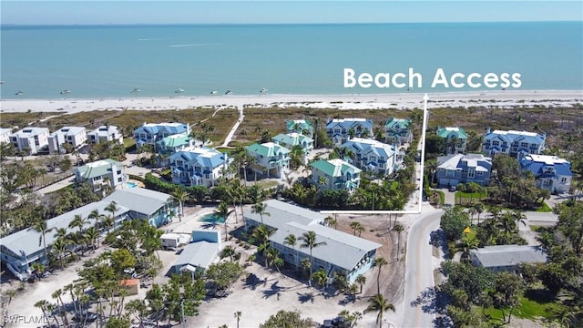 bird's eye view featuring a residential view, a view of the beach, and a water view