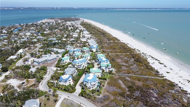 aerial view featuring a view of the beach and a water view