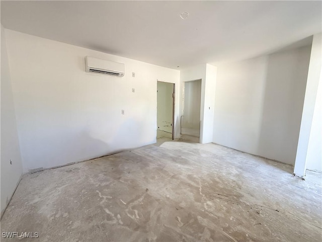 spare room with concrete floors and a wall unit AC