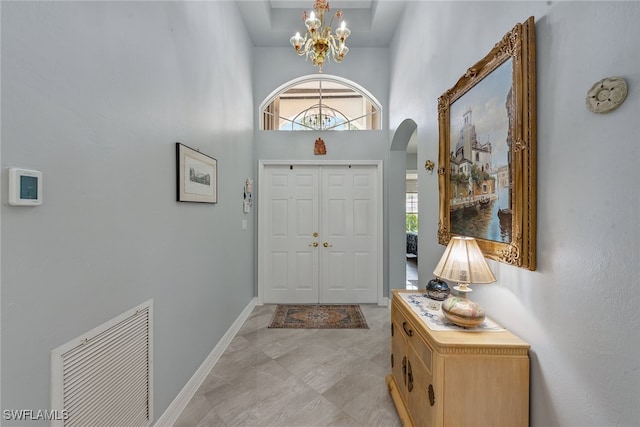 entrance foyer with a high ceiling and an inviting chandelier