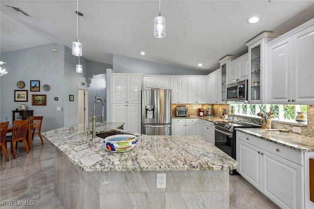 kitchen featuring vaulted ceiling, appliances with stainless steel finishes, and a spacious island