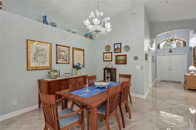 dining area featuring a chandelier and high vaulted ceiling