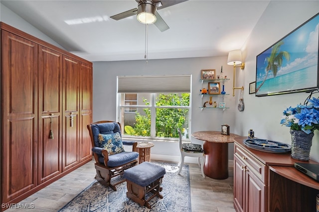 living area featuring ceiling fan, lofted ceiling, and light hardwood / wood-style floors