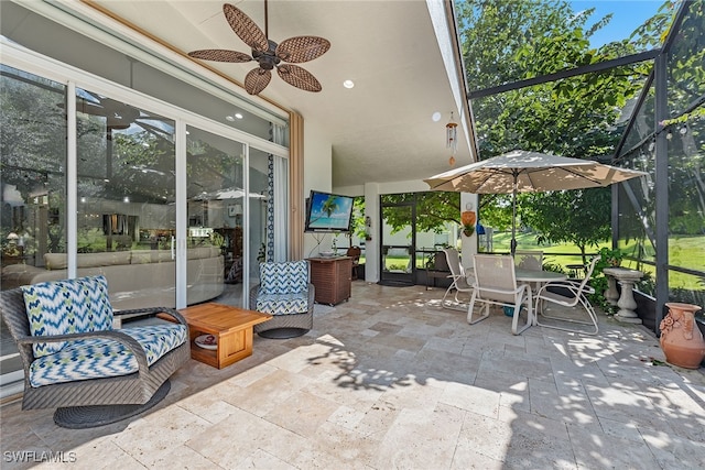 view of patio with glass enclosure and ceiling fan