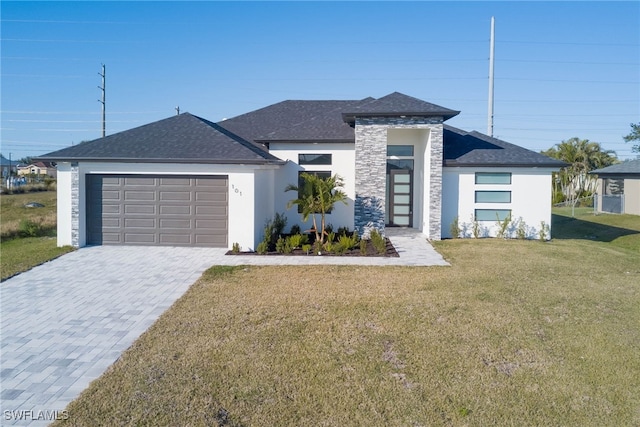 view of front of property with a front yard and a garage