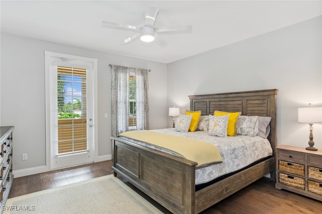 bedroom with ceiling fan, dark wood-type flooring, and access to exterior