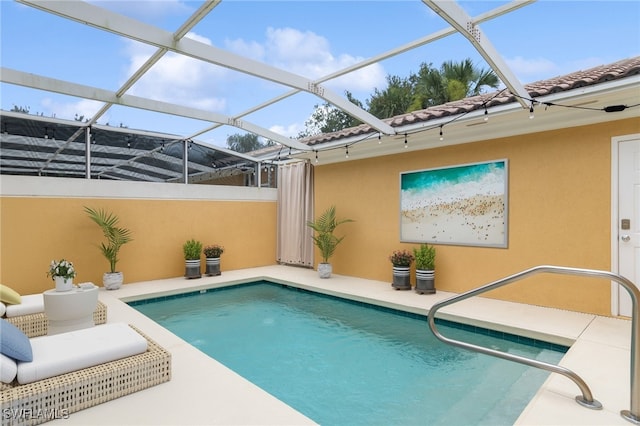 view of swimming pool with a lanai and a patio