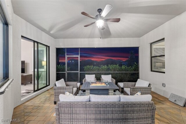 interior space featuring an outdoor hangout area and ceiling fan