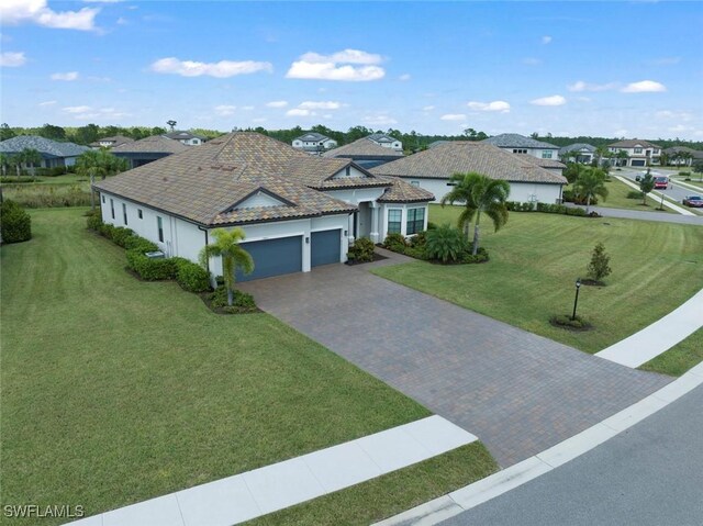 ranch-style home with a front yard and a garage