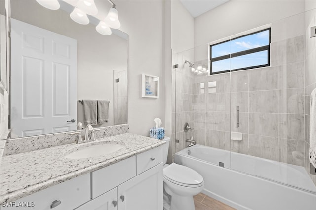 full bathroom with toilet, vanity, shower / bath combination with glass door, and tile patterned flooring