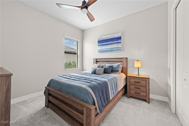 carpeted bedroom with a closet and ceiling fan