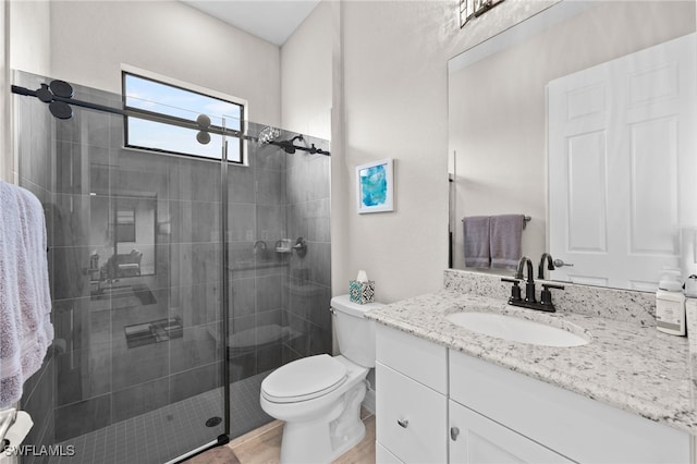 bathroom with vanity, an enclosed shower, and toilet