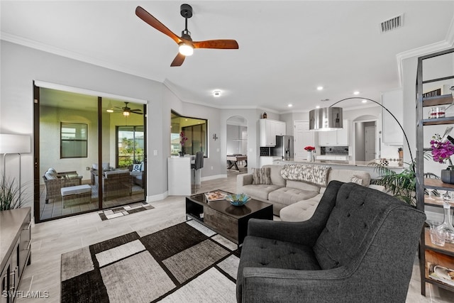 living room with crown molding and ceiling fan