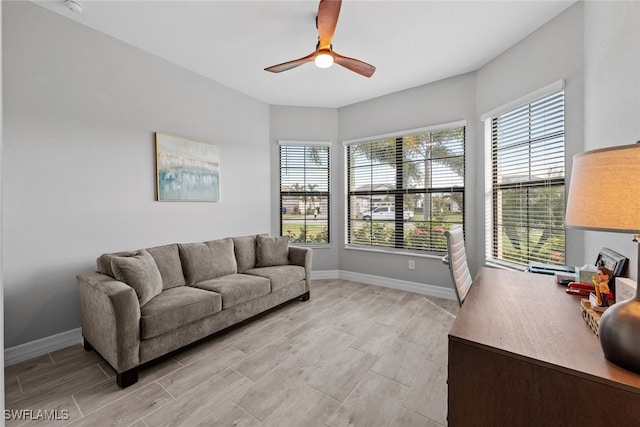 living room with a healthy amount of sunlight and ceiling fan