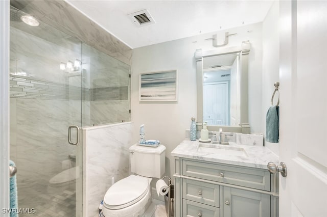 bathroom featuring vanity, toilet, and a shower with door