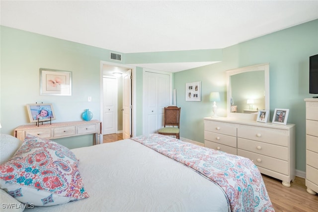 bedroom featuring light hardwood / wood-style flooring and a closet