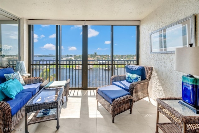 sunroom / solarium featuring plenty of natural light and a water view