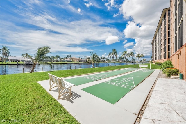 view of community featuring a yard and a water view