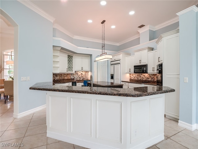 kitchen with a center island with sink, crown molding, and black appliances