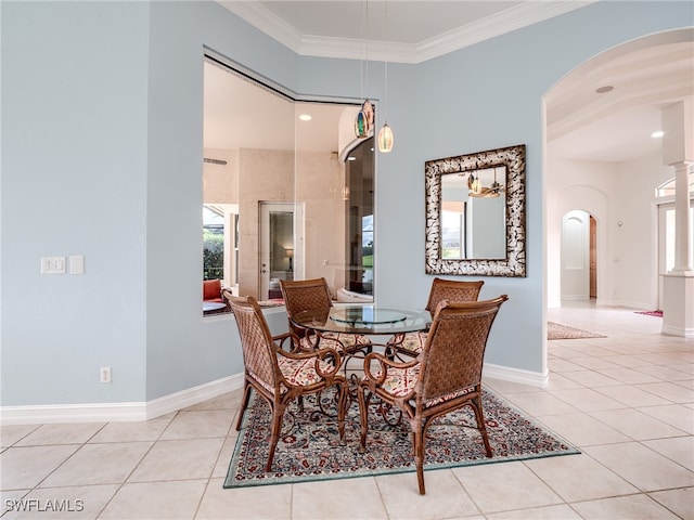 tiled dining space featuring ornamental molding