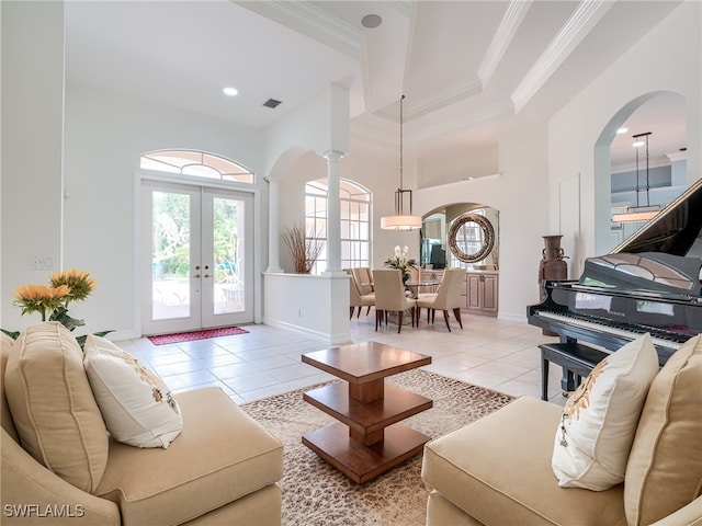 tiled living room with crown molding, french doors, and ornate columns