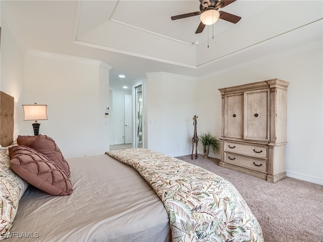 carpeted bedroom featuring crown molding, ceiling fan, and a raised ceiling