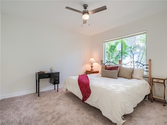 bedroom with ceiling fan and light colored carpet