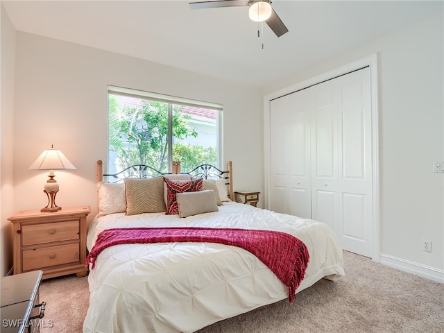 bedroom with ceiling fan, a closet, and carpet