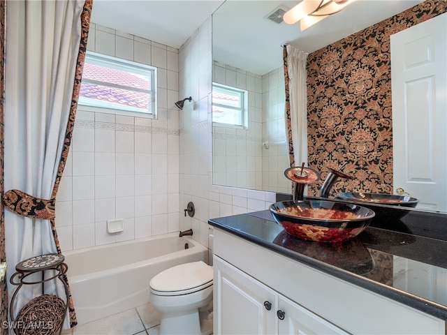 full bathroom featuring shower / bath combo with shower curtain, tile patterned floors, vanity, and toilet