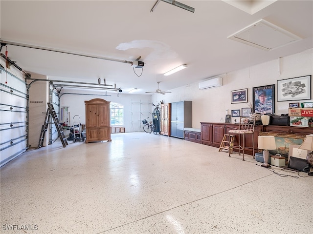 garage featuring a garage door opener, an AC wall unit, and ceiling fan