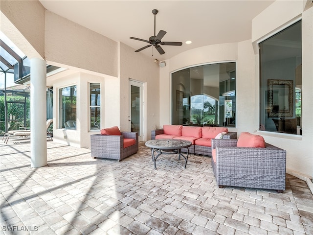 view of patio / terrace with an outdoor living space, a lanai, and ceiling fan