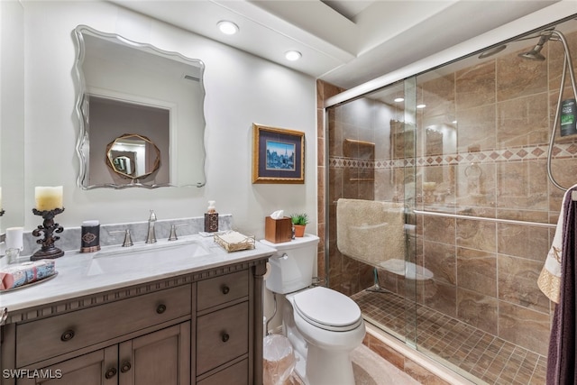 bathroom with vanity, toilet, and an enclosed shower