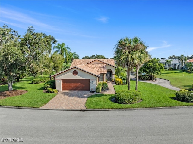 view of front of property featuring a front yard and a garage