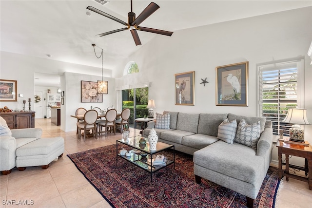 tiled living room featuring high vaulted ceiling and ceiling fan