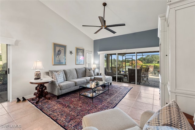 tiled living room with ceiling fan and high vaulted ceiling