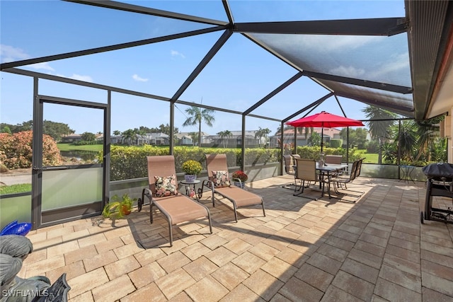 view of patio with glass enclosure