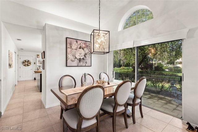 dining space with an inviting chandelier, light tile patterned floors, and high vaulted ceiling